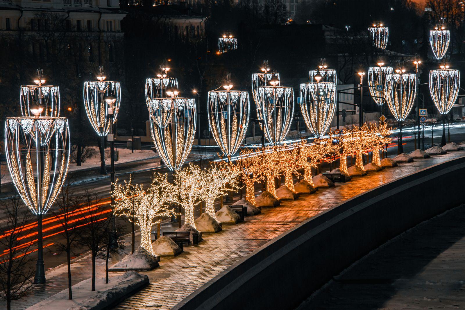 FOTO: panoramica di una via con più luminarie accese, notturna